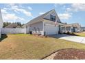 A charming home with a well-maintained lawn and fenced-in yard is shown in this image at 294 Portofino Dr., Myrtle Beach, SC 29579
