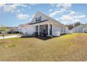 Side view of a charming home with a well-maintained lawn and white picket fence at 294 Portofino Dr., Myrtle Beach, SC 29579