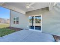 Covered patio with sliding glass doors and a ceiling fan for outdoor living at 324 Mayflower Dr., Calabash, NC 28467