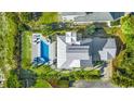 Aerial view of luxurious backyard with pool, palm trees, outdoor seating, and pristine landscaping at 3806 North Ocean Blvd., Myrtle Beach, SC 29577