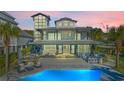 Beautiful home exterior featuring a pool, bar, glass balcony, and picturesque sunset sky at 3806 North Ocean Blvd., Myrtle Beach, SC 29577
