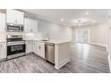 Modern kitchen with white cabinets, stainless steel appliances, and quartz countertops at 395 S Crow Creek Dr. # 1708, Calabash, NC 28467