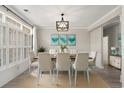 Bright dining room featuring a modern chandelier, stylish decor, and light-filled windows at 4222 Congressional Dr., Myrtle Beach, SC 29579