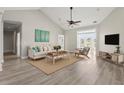 Bright living room with vaulted ceiling, wood floors, comfortable furniture, and french doors to the outside at 4222 Congressional Dr., Myrtle Beach, SC 29579