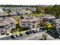 Gorgeous aerial view of the condo and complex with lush landscaping and ample parking in a desirable location at 4234 Pinehurst Circle # L1, Little River, SC 29566