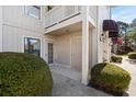 Charming condo entrance featuring well-maintained landscaping, a cozy awning, and easy access to the building's interior at 4234 Pinehurst Circle # L1, Little River, SC 29566