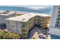 Overhead view of the beach condo building with the ocean and palm trees nearby at 4305 S Ocean Blvd. # 301, North Myrtle Beach, SC 29582
