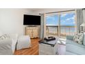 Bright living room with sliding glass door to balcony that overlooks the beach at 4305 S Ocean Blvd. # 301, North Myrtle Beach, SC 29582