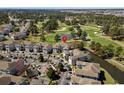 Aerial view showcases the property nestled near a golf course with lush trees and multiple parking spots at 4709 Wild Iris Dr. # 305, Myrtle Beach, SC 29577