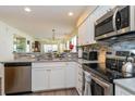 Bright kitchen featuring stainless appliances and a lovely view into the living area at 478 Pinehurst Ln. # 17D, Pawleys Island, SC 29585