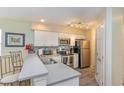 Beautiful kitchen featuring stainless appliances, a breakfast bar and white cabinets at 478 Pinehurst Ln. # 17D, Pawleys Island, SC 29585