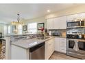 Well-lit kitchen featuring stainless steel appliances, white cabinets, and stone backsplash at 478 Pinehurst Ln. # 17D, Pawleys Island, SC 29585