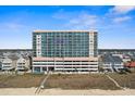 Exterior view of a high-rise condo building with ocean views and a community pool at 5700 N Ocean Blvd. # 1107, North Myrtle Beach, SC 29582