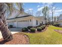 Villa featuring pristine white facade, garage, and manicured landscaping at 640 Intracoastal Way # 640, Myrtle Beach, SC 29579