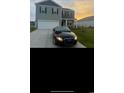 Beautiful two-story home with well-kept lawn and paved driveway featuring a sporty black car at 645 Black Pearl Way, Myrtle Beach, SC 29588