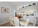 Bright dining room featuring chandelier, glass-top table with chairs, and built-in cabinets at 6904 Gina Ct., Myrtle Beach, SC 29588