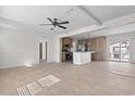 Open concept living space with wood floors, ceiling fan, and an opening to the kitchen at 909 Pine Thicket St., Myrtle Beach, SC 29577