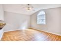 Bright living room featuring light hardwood floors, a ceiling fan, and a large arched window at 1161 Ganton Way, Myrtle Beach, SC 29588