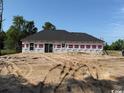 Exterior back featuring white siding and a sliding glass door at 1278 Highway 45, Loris, SC 29569