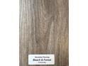 Sample of Shoreline Flooring's Beach & Forest laminate, showing natural woodgrain texture at 1284 Highway 45, Loris, SC 29569