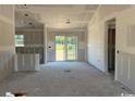 Spacious living room under construction with sliding glass doors leading to the yard at 1284 Highway 45, Loris, SC 29569