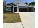 Charming home featuring a three-car garage, manicured lawn, and a classic, inviting facade at 191 Glengrove Lane, Murrells Inlet, SC 29576