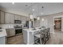 Well-equipped kitchen with stainless steel appliances, gray cabinets, pendant lighting, and breakfast bar seating at 191 Glengrove Lane, Murrells Inlet, SC 29576
