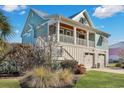 Charming two-story home features a two-car garage, a second floor patio, and lush landscaping at 392 Eagle Pass Dr., Murrells Inlet, SC 29576