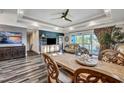 Spacious living room features a large dining table and hardwood floors, leading to a view of the pool at 392 Eagle Pass Dr., Murrells Inlet, SC 29576