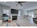 Open-concept living room featuring a fireplace, modern ceiling fan, and dining area at 4237 Brook Dr., Murrells Inlet, SC 29576