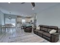 Bright, open living room with wood floors, connecting the kitchen and dining areas at 4237 Brook Dr., Murrells Inlet, SC 29576