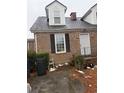 Side view of a brick house with windows and minimal landscaping, showing trash receptacles at 4300 Summitt Trail, Myrtle Beach, SC 29579