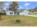 Well-kept one-story home featuring an attached garage and a grassy front lawn at 445 Saint Charles Circle, Myrtle Beach, SC 29588