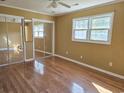 Bedroom with wood floors, closet with mirrored doors, and natural light from a window at 4661 Redwood Dr., Myrtle Beach, SC 29588