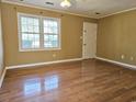 Bright bedroom featuring wood floors, a large window, and neutral-toned walls at 4661 Redwood Dr., Myrtle Beach, SC 29588