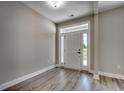 Inviting entryway with light-colored walls, wood-look flooring and a door with sidelights at 646 Sunny Pond Ln., Aynor, SC 29511