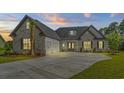 Charming two-story home with a three-car garage and an inviting entrance at dusk at 1004 Bufflehead Dr., Conway, SC 29526