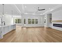 Spacious living area with wood floors, a fireplace, and an open concept to the kitchen at 1004 Bufflehead Dr., Conway, SC 29526