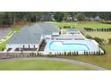 Resort-style community pool and lounge area offer a relaxing escape with lush landscaping and shade at 1997 Wild Indigo Circle Nw # 7, Calabash, NC 28467