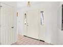 Welcoming entryway featuring neutral tile flooring, a white door, and adjacent coat closet at 1001 Cardinal Ct., Murrells Inlet, SC 29576