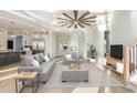 Bright living room boasts coffered ceilings, hardwood floors, and access to an open kitchen and sunlit entryway at 105 Serenity Point Dr., Little River, SC 29566