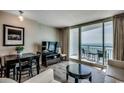 Comfortable living room with ocean views from the balcony and sleek, modern furnishings at 107 S Ocean Blvd. # 1407, Myrtle Beach, SC 29577