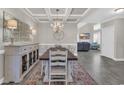 Bright dining room showcasing decorative furnishings, a chandelier, and seamless flow to the living room at 1109 Bonnet Dr., North Myrtle Beach, SC 29582