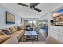 Bright living room boasts comfortable seating and a scenic view from the open balcony at 121 Osprey Watch Circle # 9-C, Pawleys Island, SC 29585