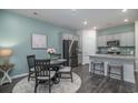 Stylish eat-in kitchen with stainless steel appliances, granite countertops, and a cozy dining area for four at 164 Vineyard Place # 23, Pawleys Island, SC 29585