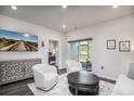 Bright living room features a TV, sliding doors to a screened porch, and an open doorway to a bedroom at 164 Vineyard Place # 23, Pawleys Island, SC 29585