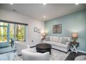 Inviting living room with a cozy seating arrangement, stylish decor, and access to a screened porch, perfect for relaxing at 164 Vineyard Place # 23, Pawleys Island, SC 29585