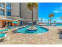 The swimming pool area has an island pool, plenty of room and lounge chairs at 205 74Th Ave. N # 904, Myrtle Beach, SC 29572