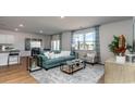 Bright living room featuring stylish furniture, a patterned rug, and large windows with views of the water at 211 Calm Dr., Little River, SC 29566