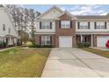 Charming two-story townhome featuring a brick facade, attached garage, and well-maintained landscaping at 223 Connemara Dr. # A, Myrtle Beach, SC 29579